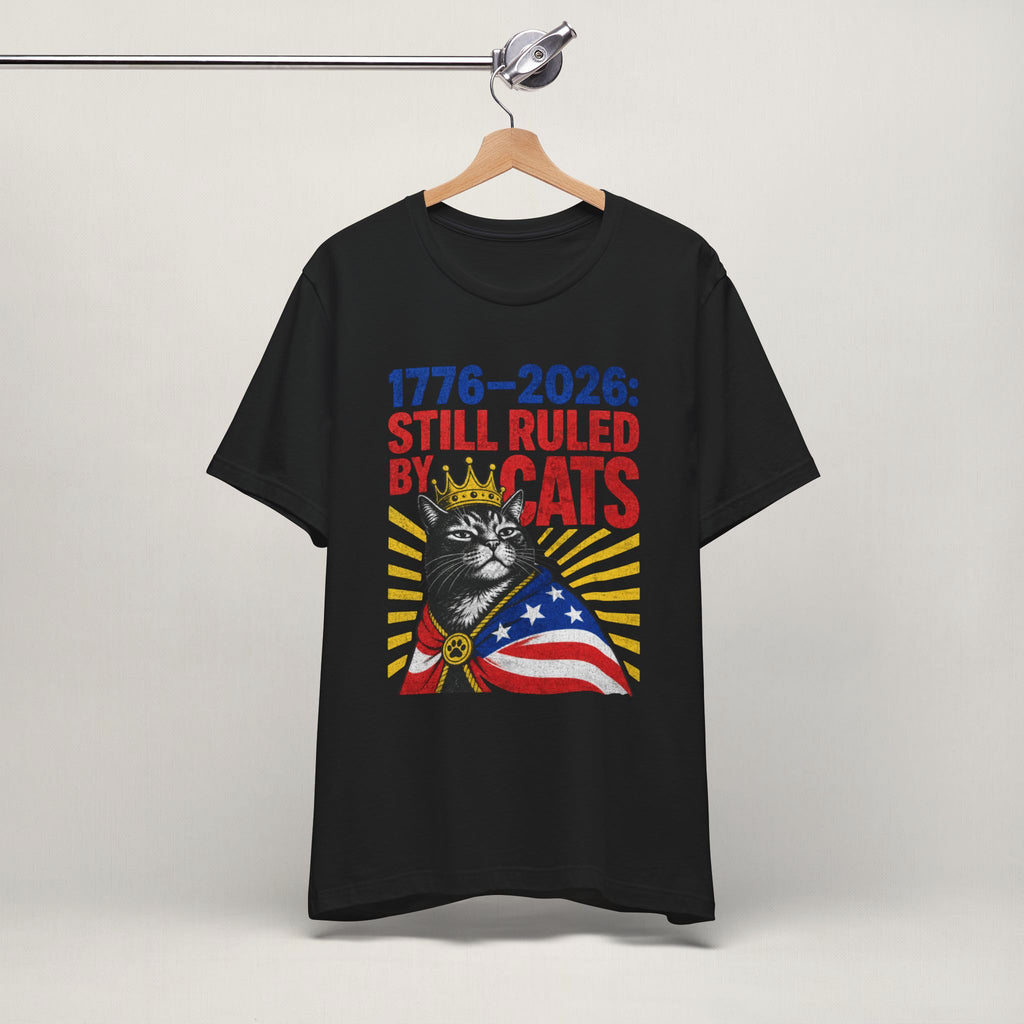 Flat lay of white graphic cat t-shirt with Still Ruled By Cats patriotic design