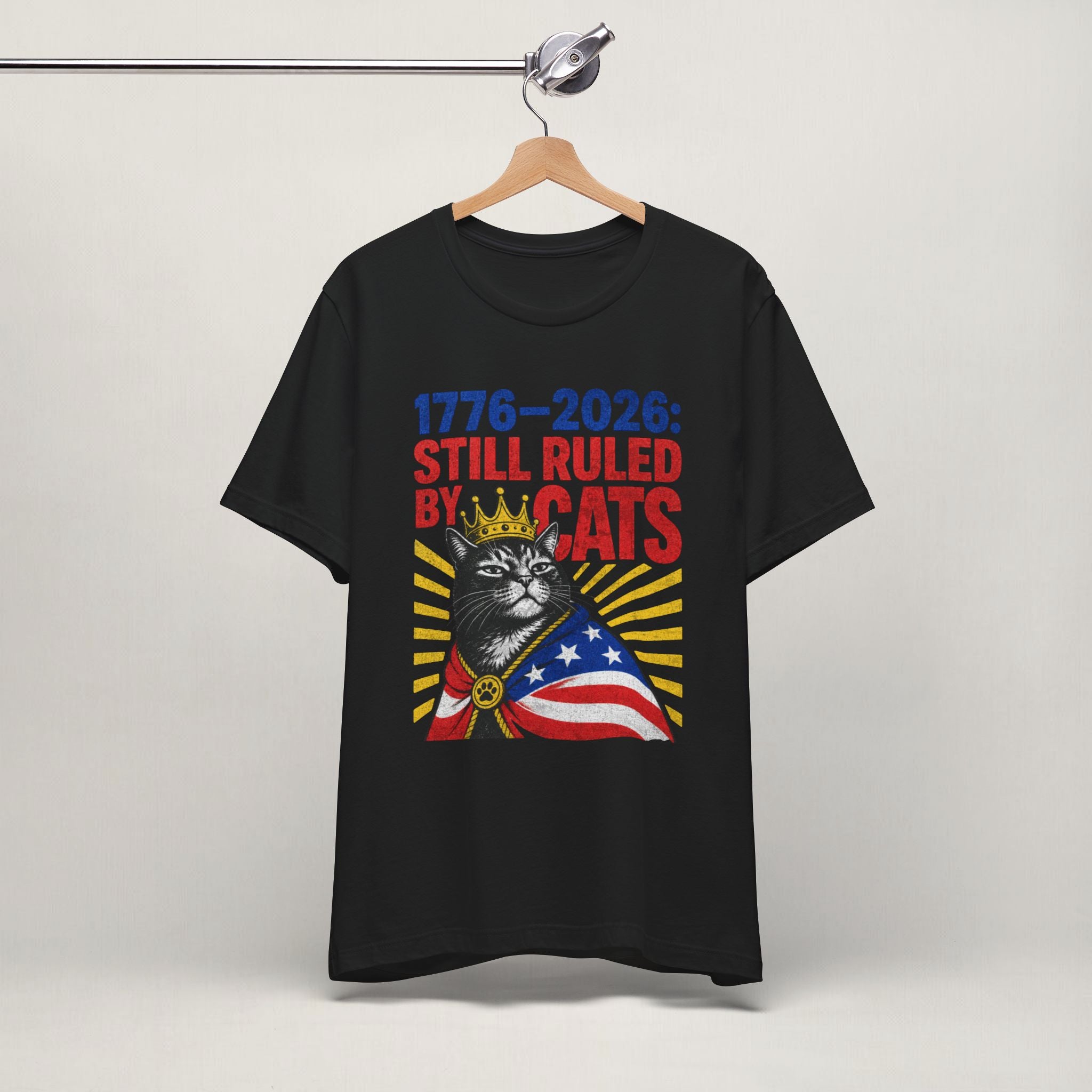 Flat lay of white graphic cat t-shirt with Still Ruled By Cats patriotic design