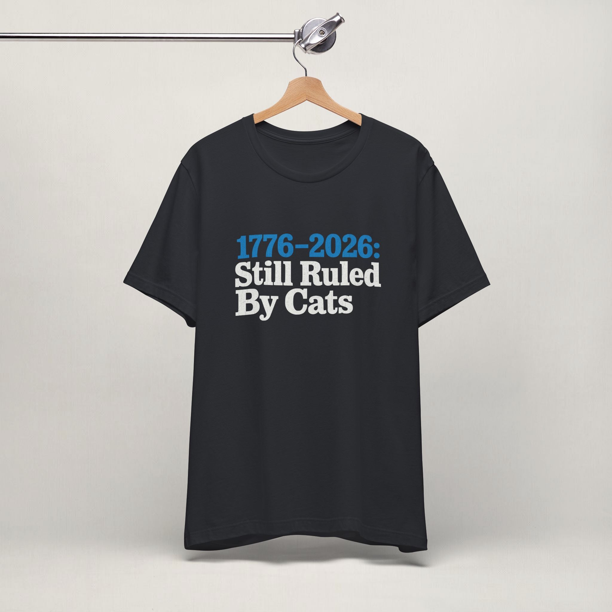Flat lay of vintage white graphic cat t-shirt with Ruled By Cats patriotic design