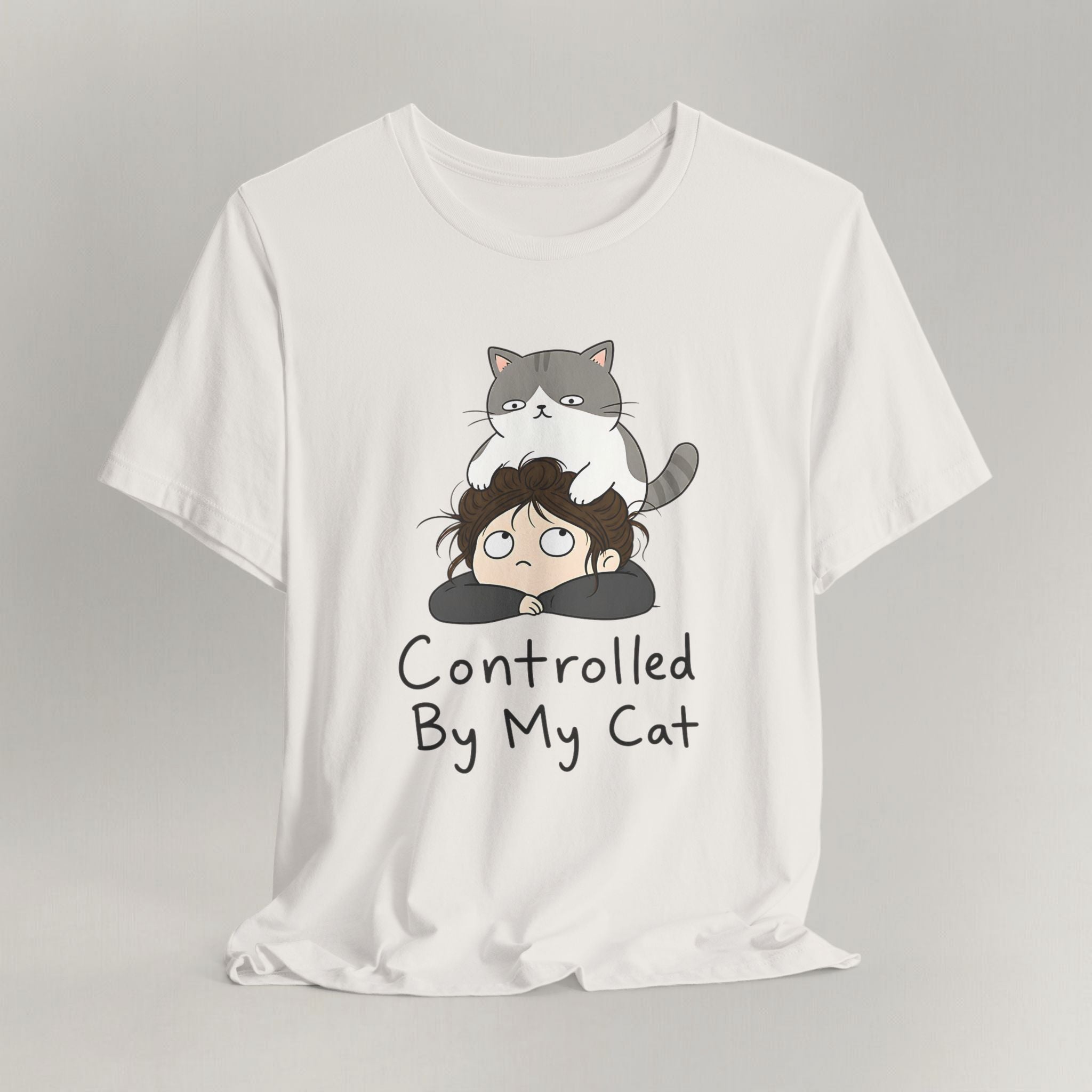 Flat lay of vintage white graphic cat t-shirt with Controlled By My Cat print design