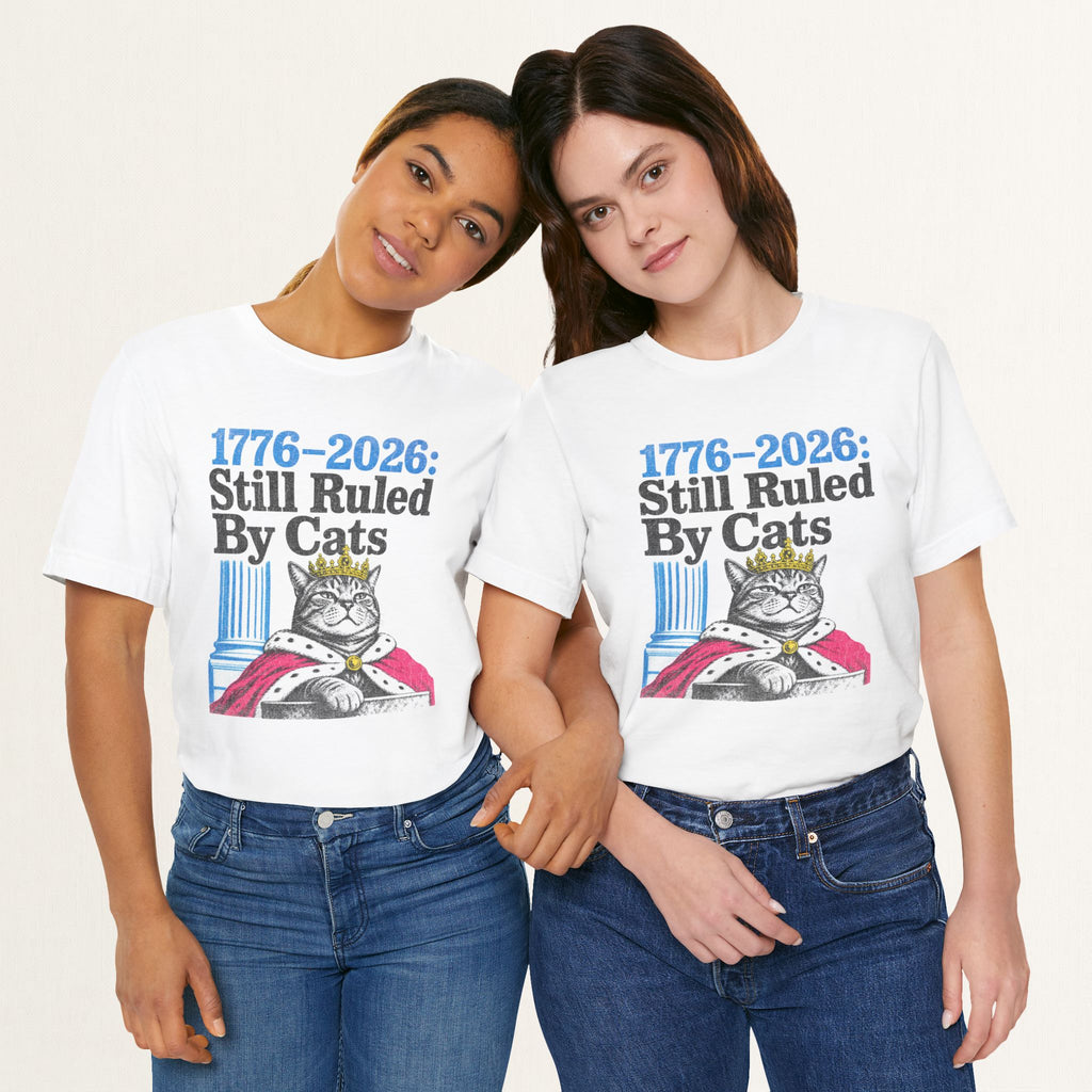 Styled flat lay of white Ruled By Cats cat graphic tee