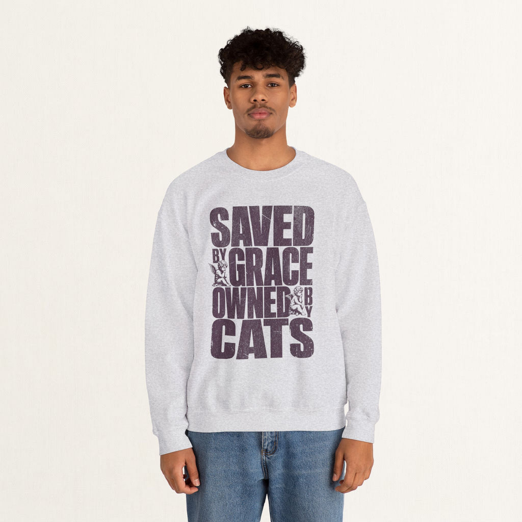 Man wearing an ash Saved by Grace Owned by Cats printed cat sweatshirt