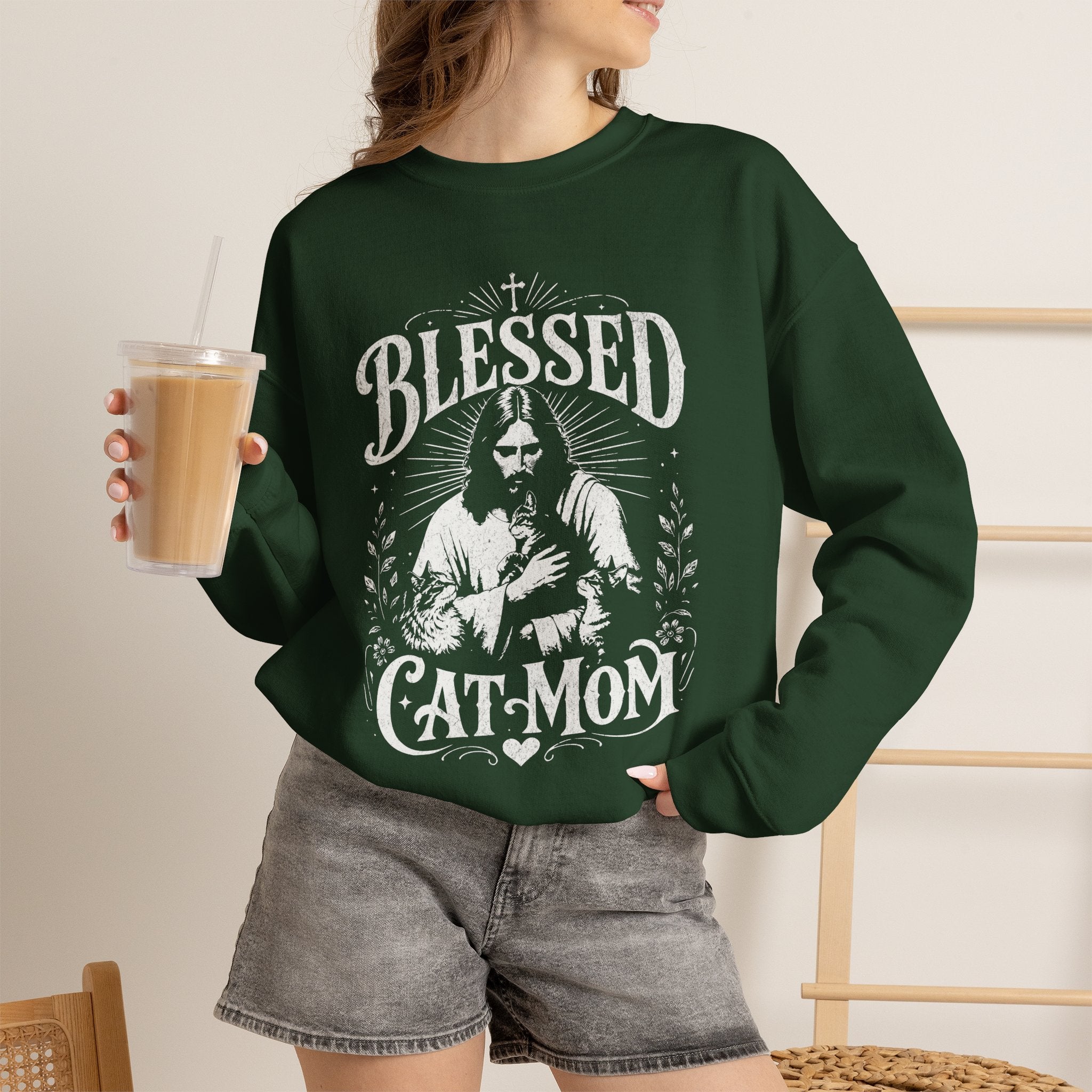 Woman wearing a forest green Blessed Cat Mom printed cat sweatshirt