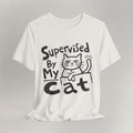 Vintage white t-shirt with hand-drawn Supervised By My Cat design, sketched cat resting on box