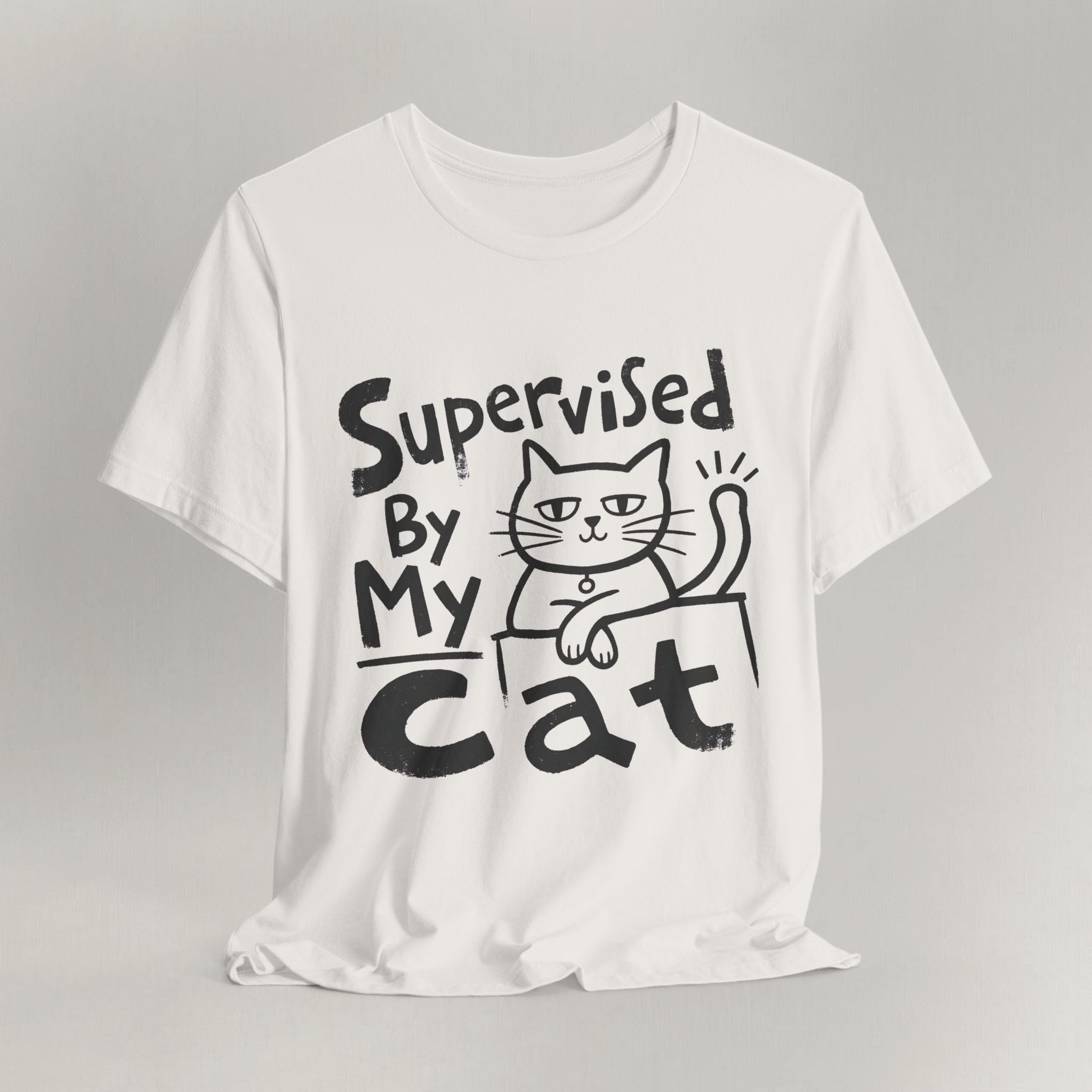 Vintage white t-shirt with hand-drawn Supervised By My Cat design, sketched cat resting on box