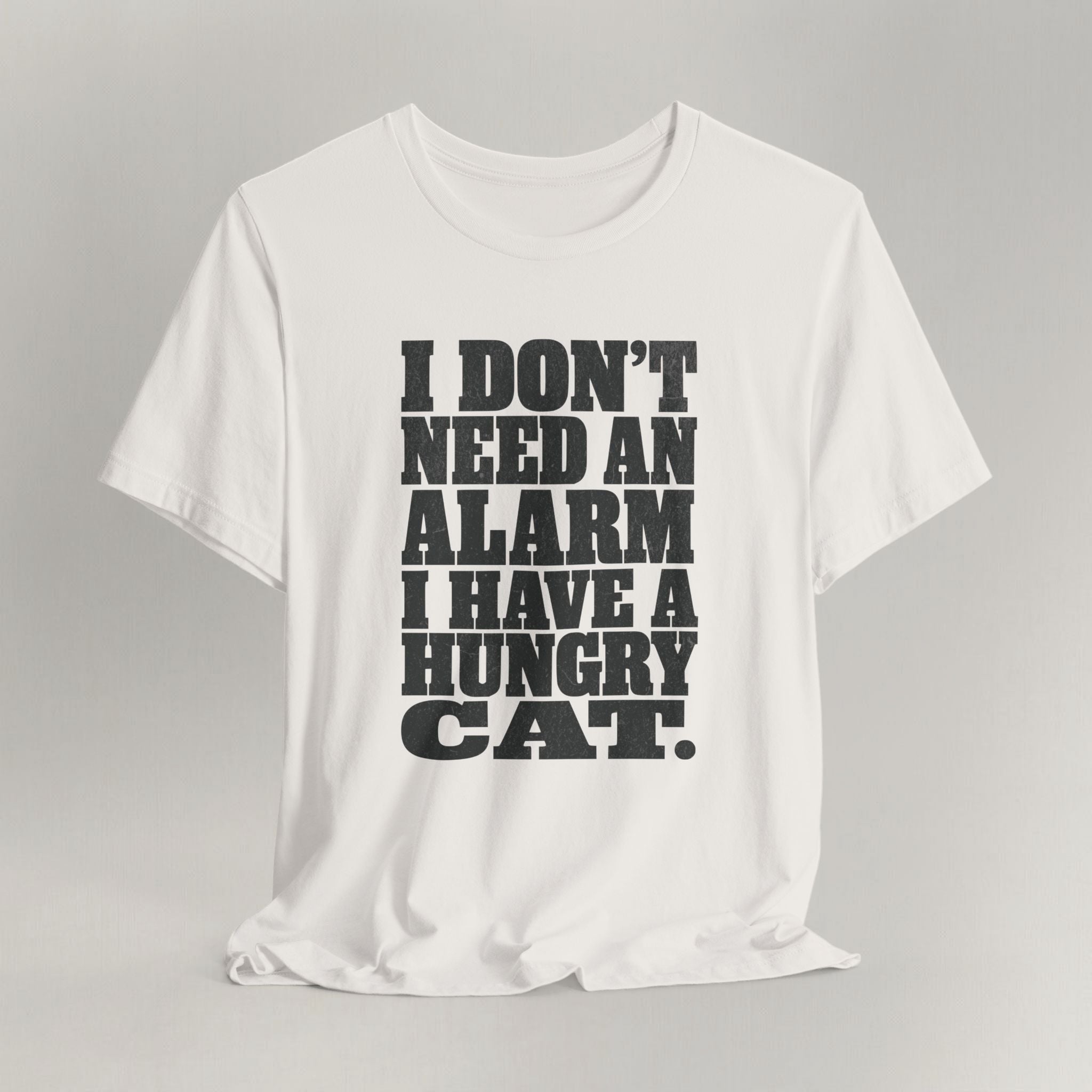 Vintage white cat t-shirt with an I Don't Need An Alarm, I Have A Hungry Cat design, shown flat