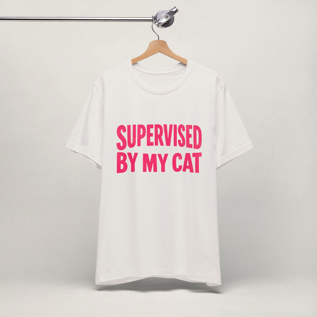 Vintage white Supervised By My Cat t-shirt with pink graphic hanging on display