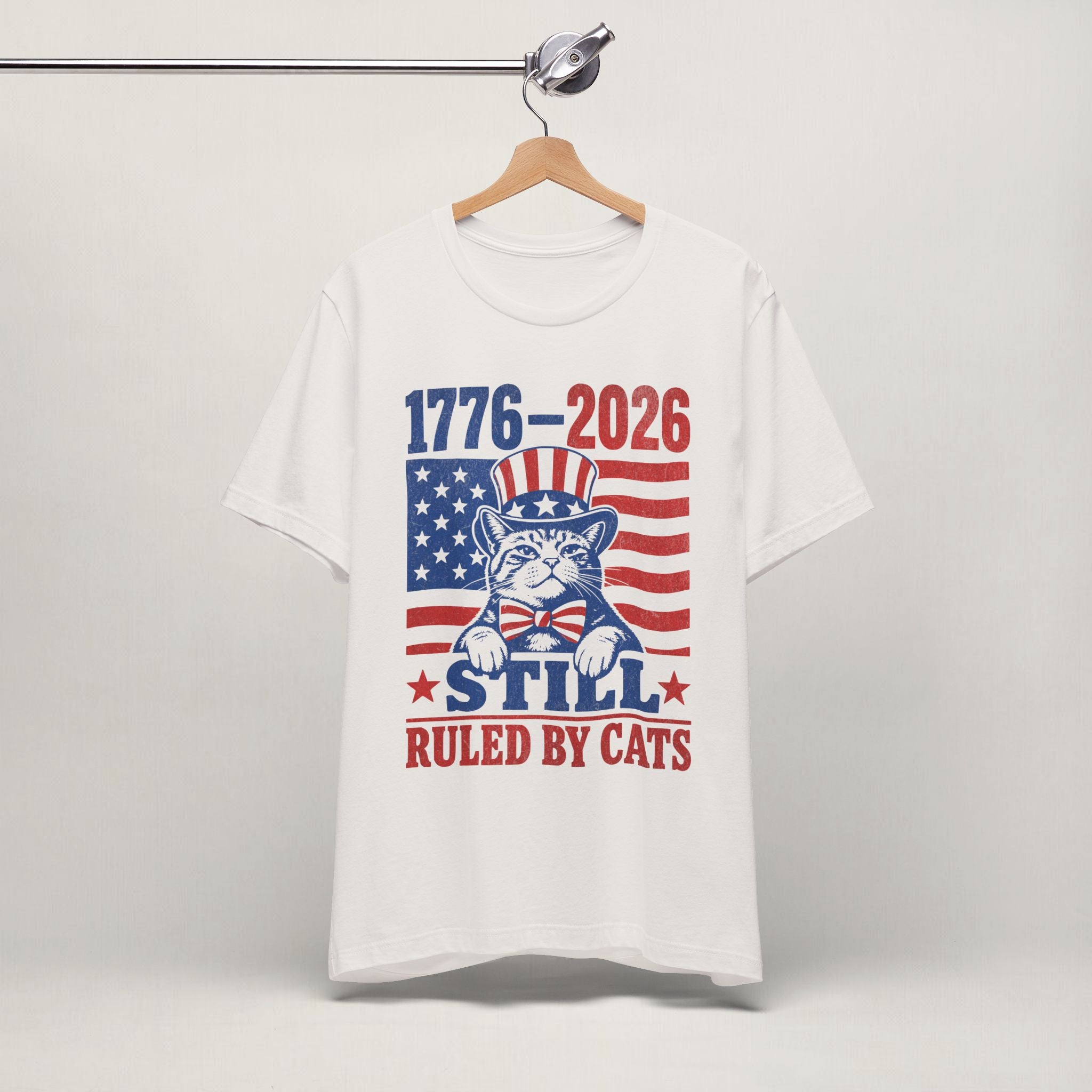 Close-up of 1776-2026 Ruled By Cats patriotic print on vintage white unisex t-shirt