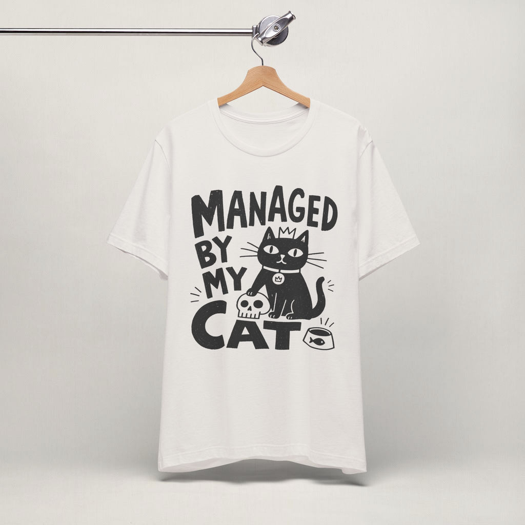 Vintage white Managed By My Cat t-shirt hanging on a wooden hanger