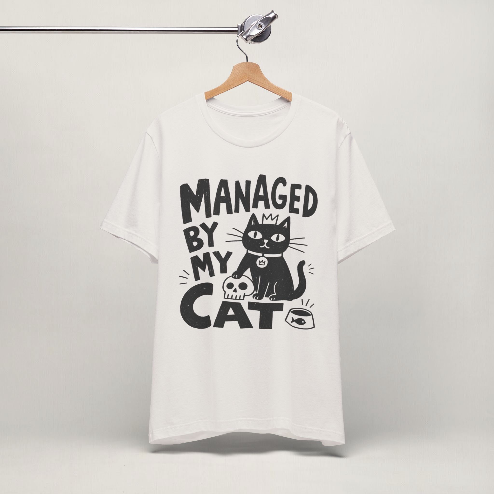 Vintage white Managed By My Cat t-shirt hanging on a wooden hanger