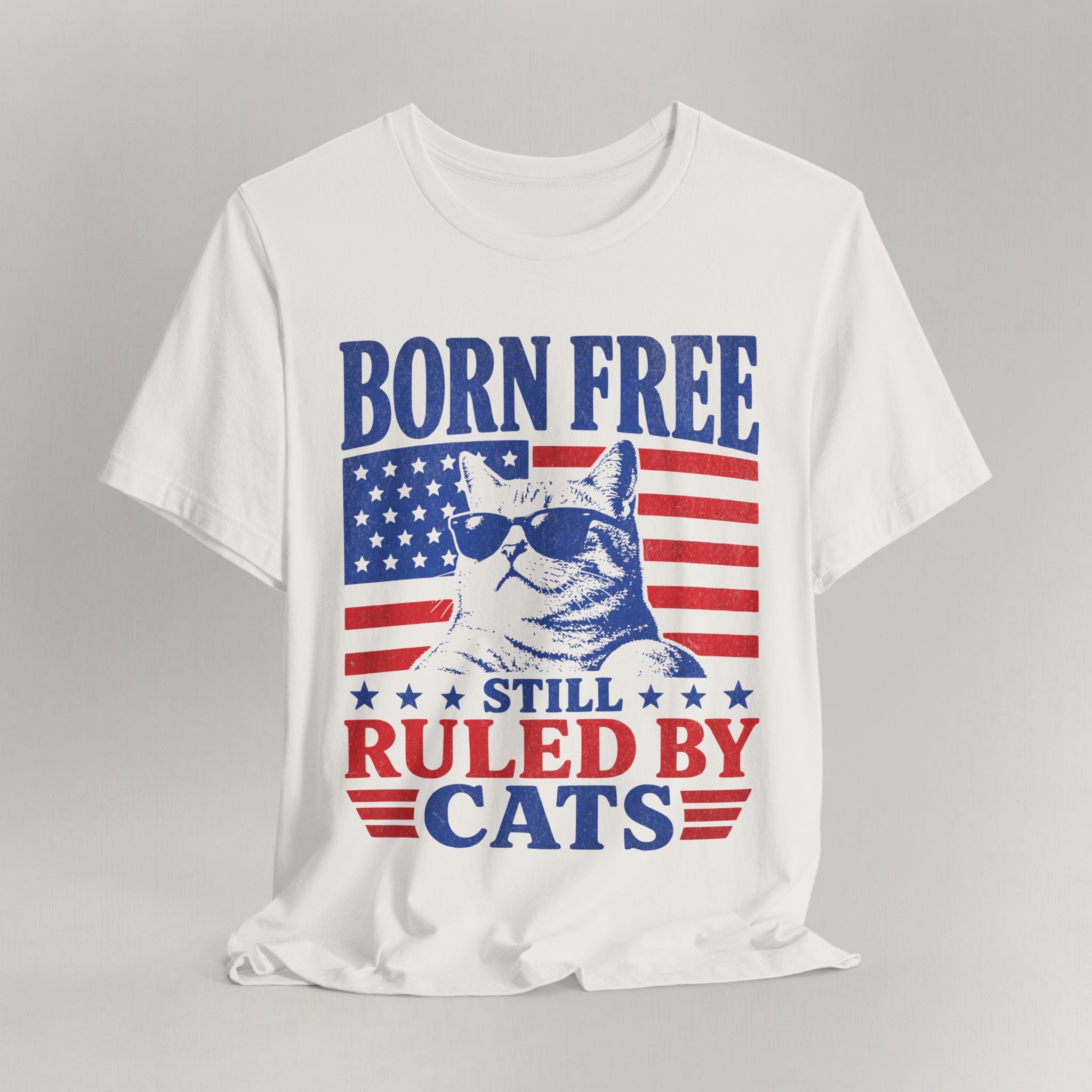 Flat lay of vintage white graphic cat t-shirt with Still Ruled By Cats print design