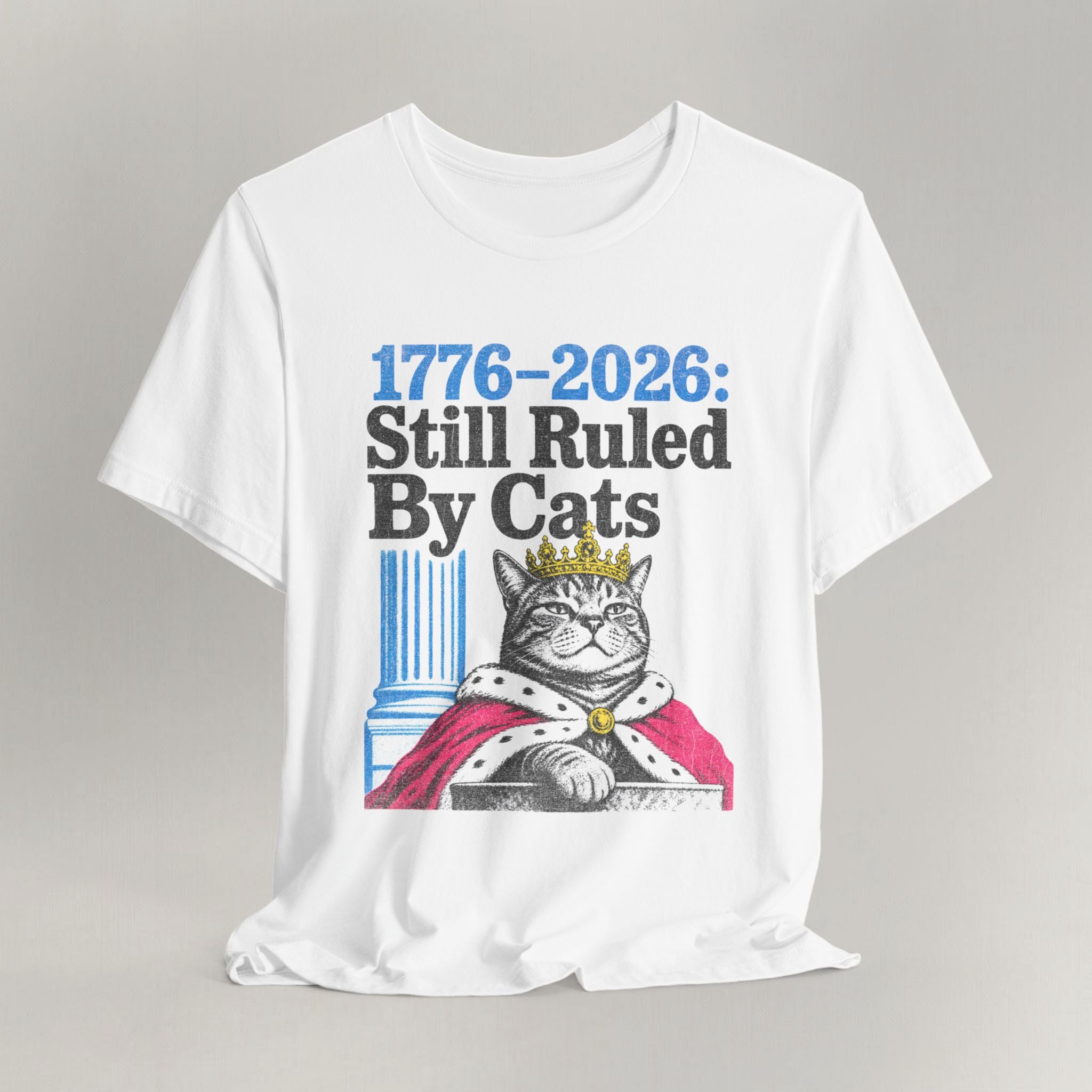 Flat lay of white graphic cat t-shirt with Ruled By Cats patriotic design