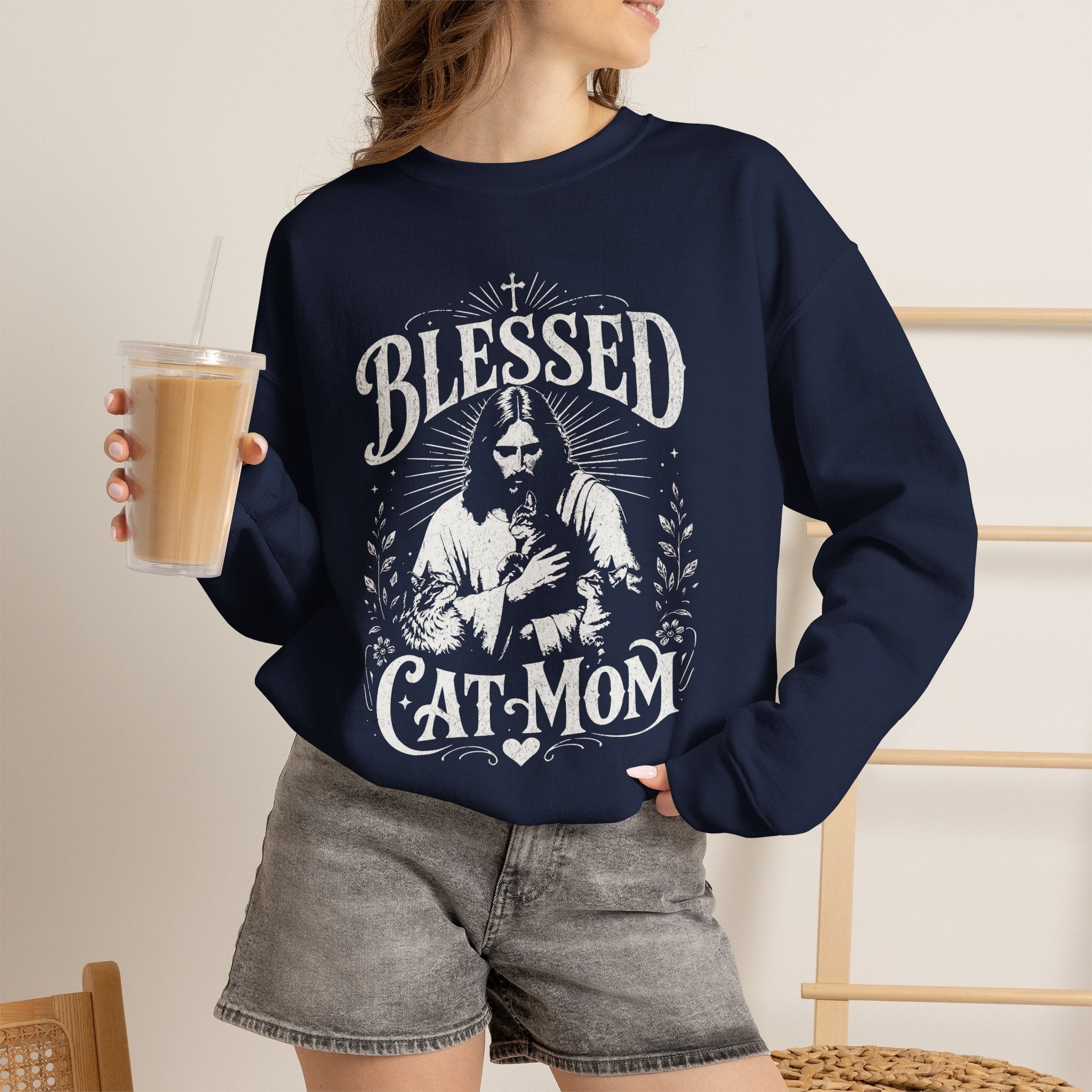 Woman wearing a navy Blessed Cat Mom printed cat sweatshirt