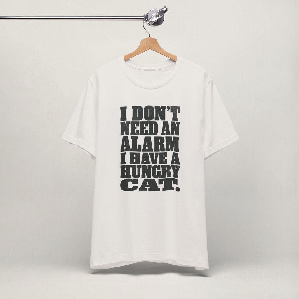 Vintage white I Don't Need An Alarm cat t-shirt on a hanger