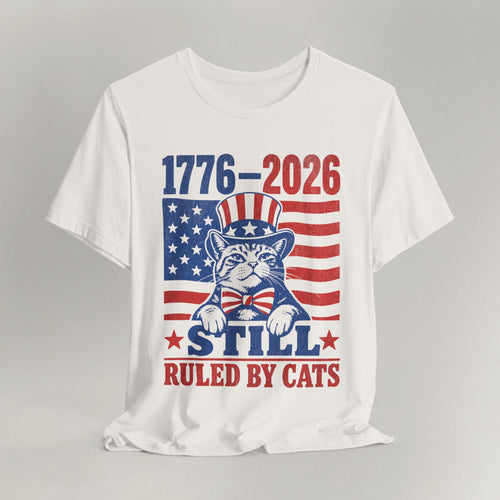 Flat lay of vintage white graphic cat t-shirt with 1776-2026 Ruled By Cats patriotic design