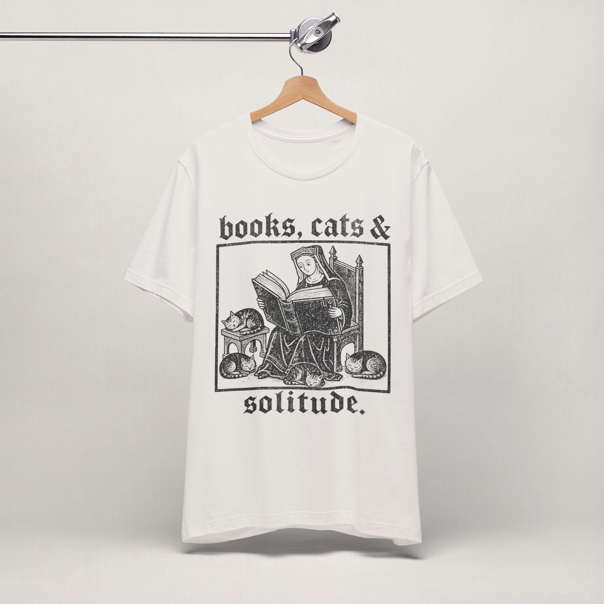Vintage white Books, Cats and Solitude cat t-shirt on a hanger