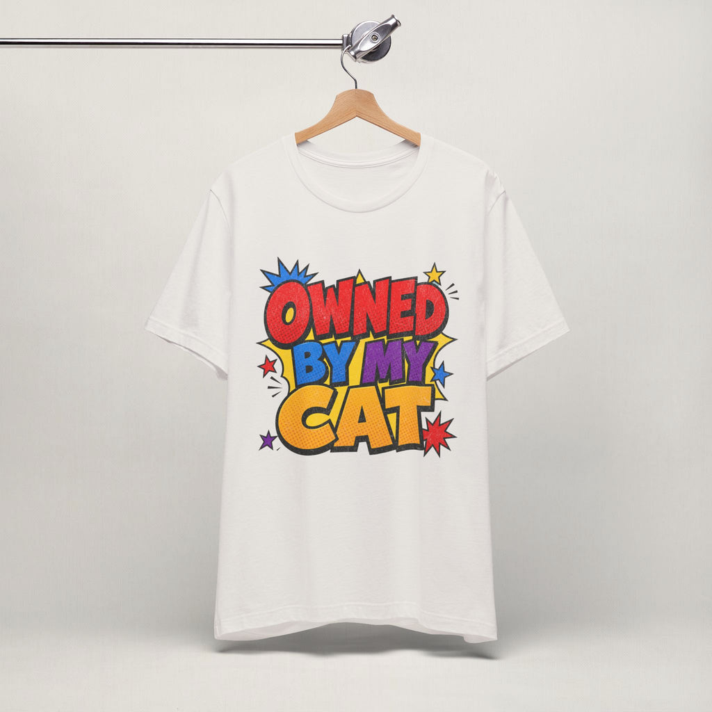 Vintage white Owned By My Cat t-shirt with colorful graphic hanging on display