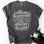 Dark gray garment-dyed cat lover graphic tee with "Always Be a Cat" ornate script design