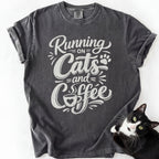 Dark gray cat lover tee with "Running on Cats and Coffee" graphic print — garment-dyed