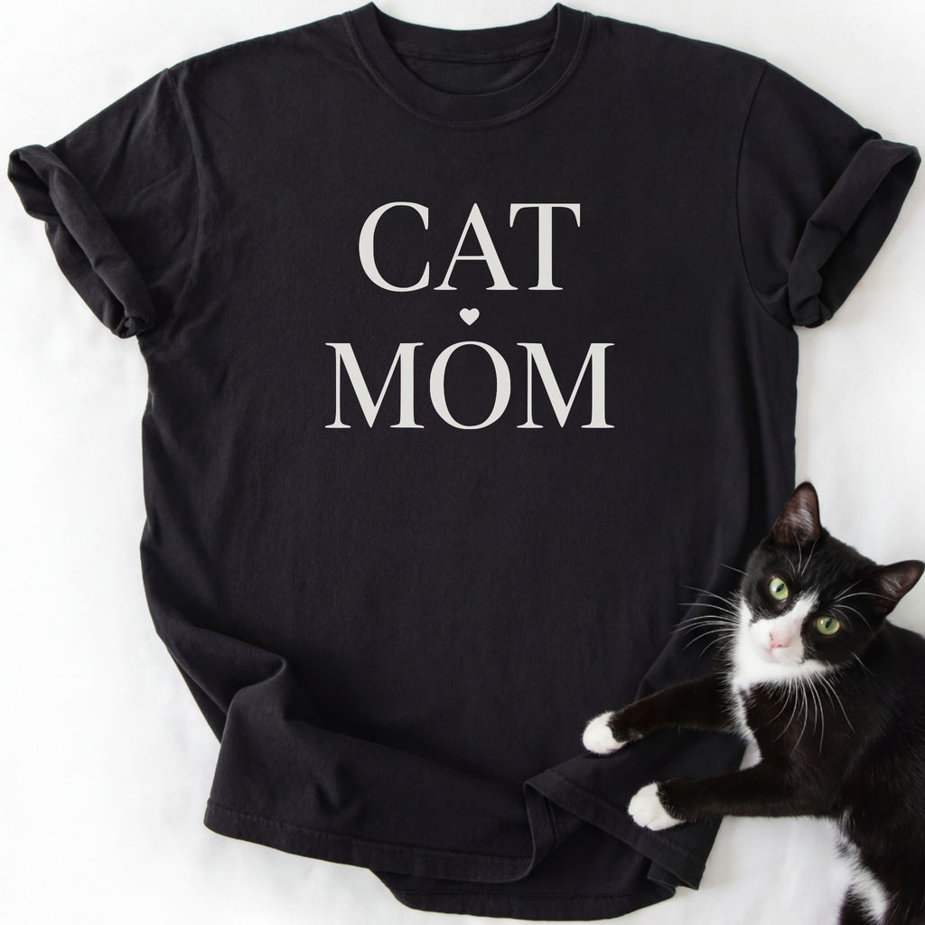 Black proud cat mom shirt with "Cat Mom" serif lettering and heart design — relaxed fit