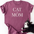 Maroon cat mom t-shirt with "Cat Mom" white serif text and heart — garment-dyed cotton