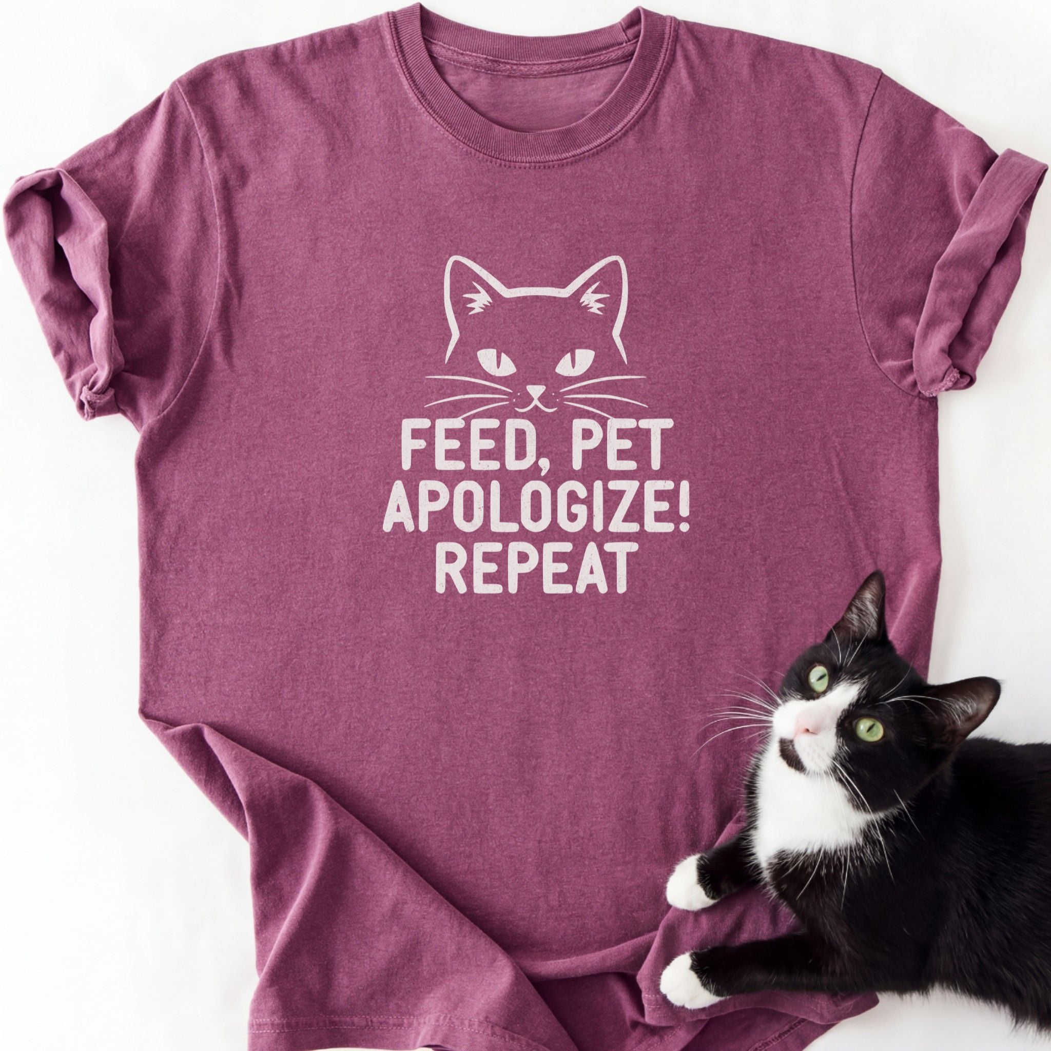 Maroon cat lover graphic tee with 'Feed Pet Apologize' text and cat outline