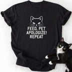 Black cat humor graphic tee with 'Feed Pet Apologize' text and white cat outline