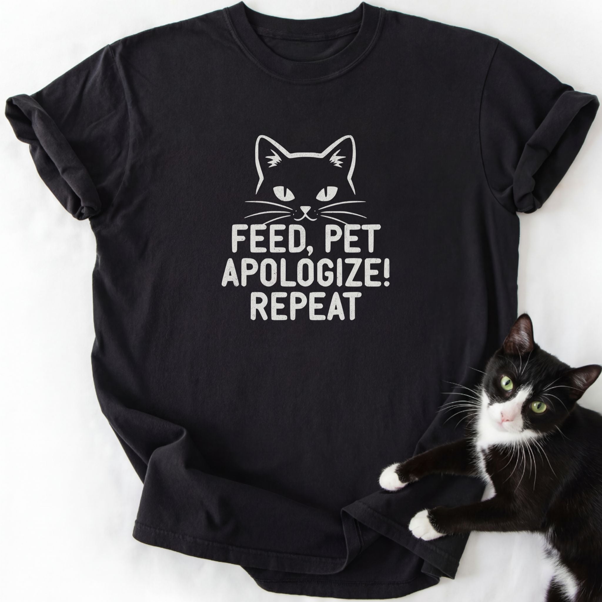 Black cat humor graphic tee with 'Feed Pet Apologize' text and white cat outline