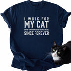Navy blue I Work For My Cat humor t-shirt featuring cat image and slogan