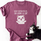 Maroon heathered Oh Look Cat graphic tee with raised arms cartoon cat print