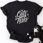 Black Cats Before Tasks graphic tee featuring cursive text and paw prints