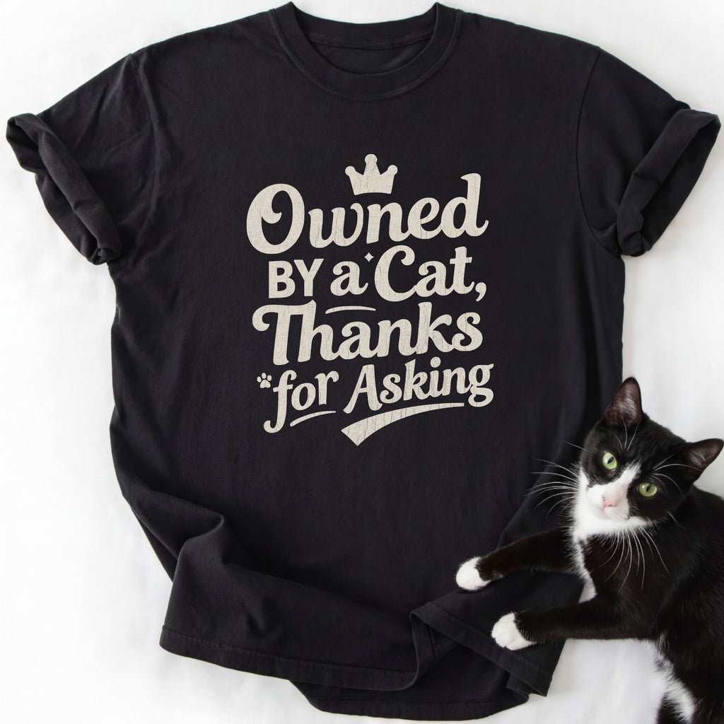 Black Owned By a Cat humor t-shirt featuring crown and paw print