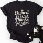 Black Owned By a Cat humor t-shirt featuring crown and paw print