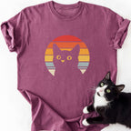 Retro black cat sunset graphic tee in heathered maroon with yellow eyes