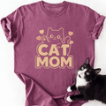 Magenta heathered Cat Mom graphic t-shirt with beige block letters and cat art
