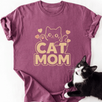 Magenta heathered Cat Mom graphic t-shirt with beige block letters and cat art