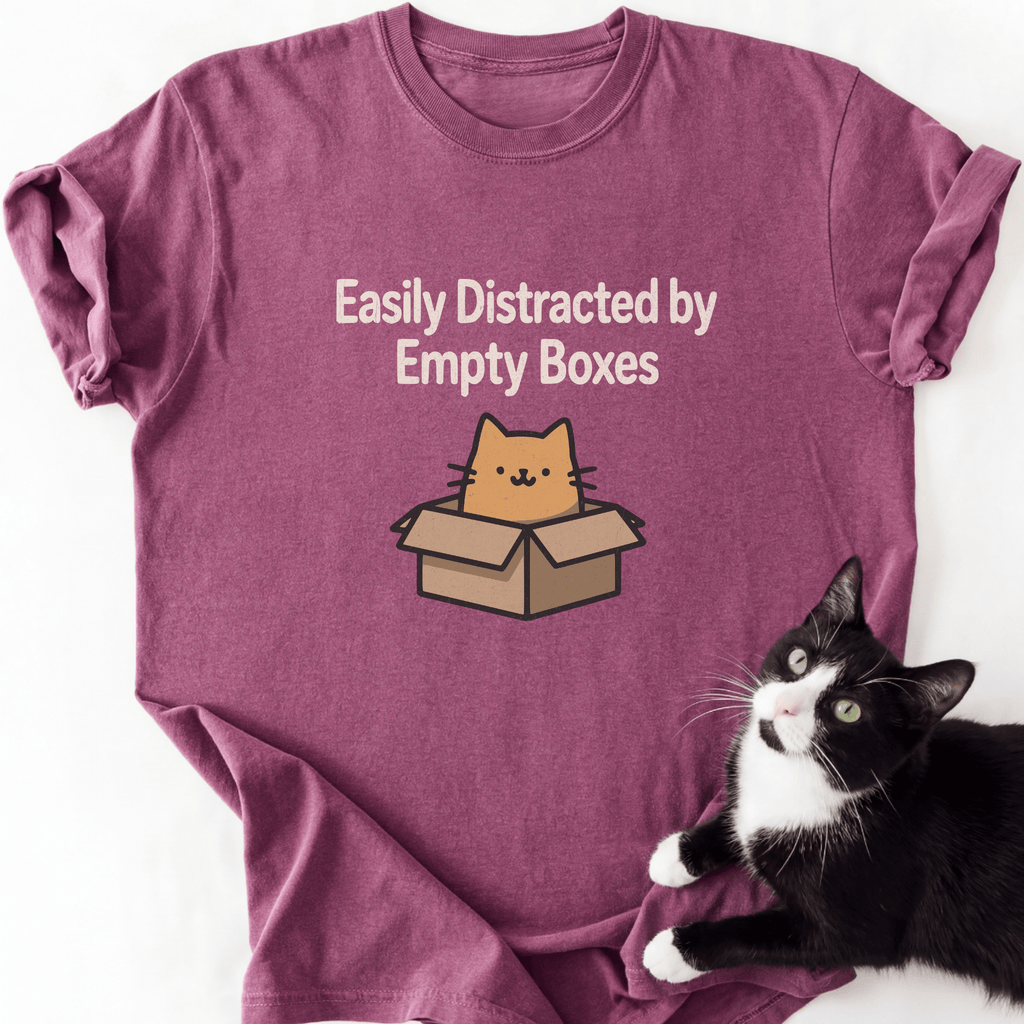 Magenta heather cat mom tee showing cartoon cat inside open box with funny text design
