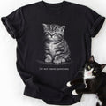 Black garment-dyed cotton tee featuring grumpy cat graphic and humorous 'Not Taking Questions' slogan