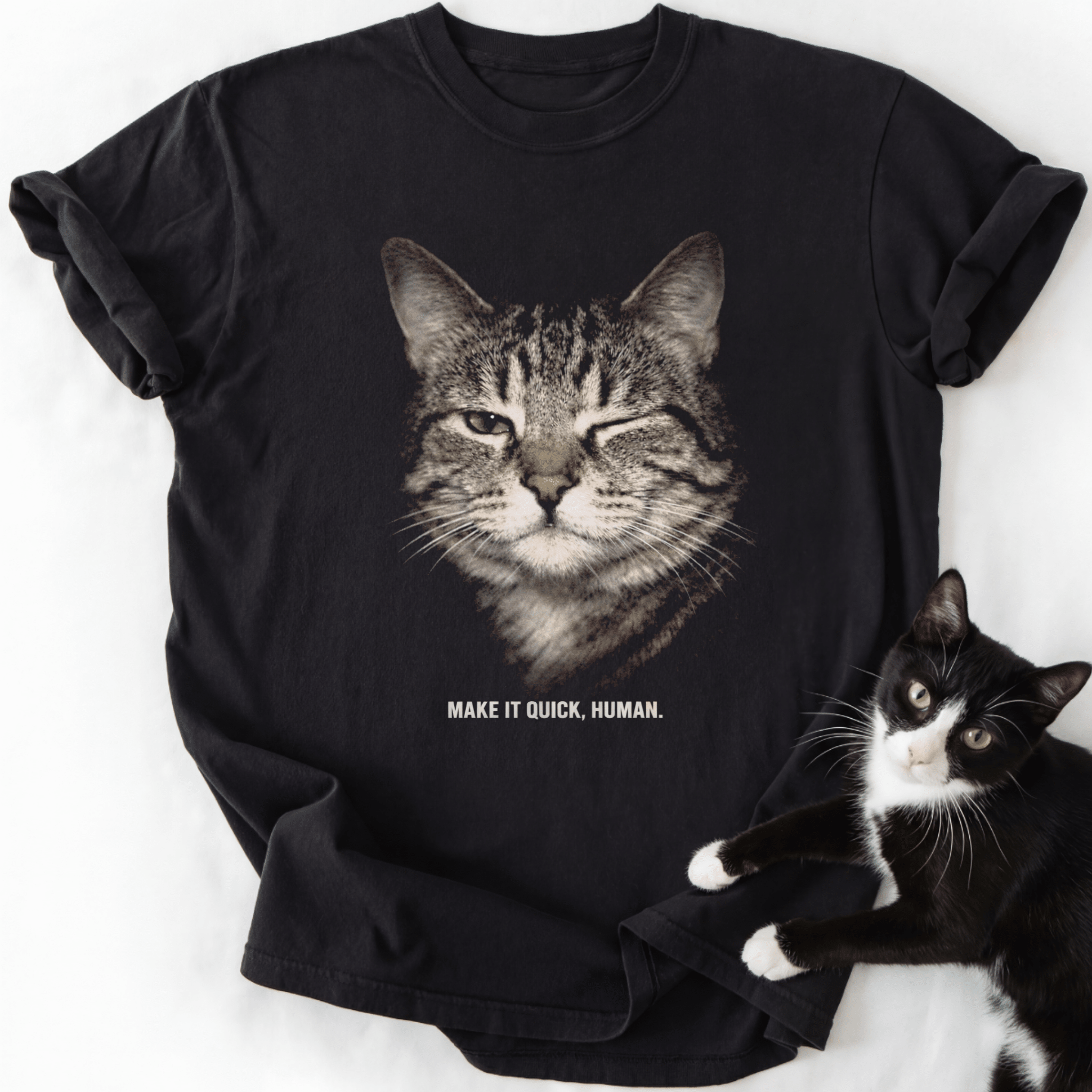 Black crew neck t-shirt with winking tabby cat design and 'Make It Quick Human' print