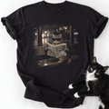 Black vintage cat graphic tee with tabby reading newspaper at bus stop