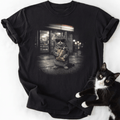 Black cat t-shirt with tabby wearing sunglasses and holding snack bag