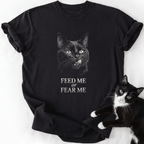 Black Feed or Fear Me cat graphic tee with grayscale cat illustration and text