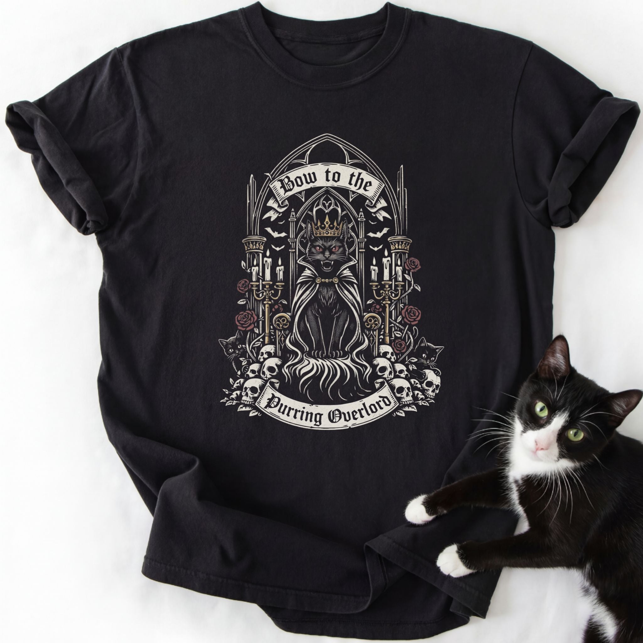 Black short-sleeve t-shirt featuring crowned cat design and 'Bow to the Purring Overlord' print