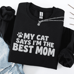 Black cat mom embroidered sweatshirt with “My Cat Says I’m The Best Mom” text, folded flat on light denim