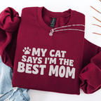 Maroon cat mom embroidered sweatshirt with “My Cat Says I’m The Best Mom” text, folded flat on light denim