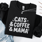Black cats coffee mama embroidered sweatshirt with paw print detail, folded flat on light denim