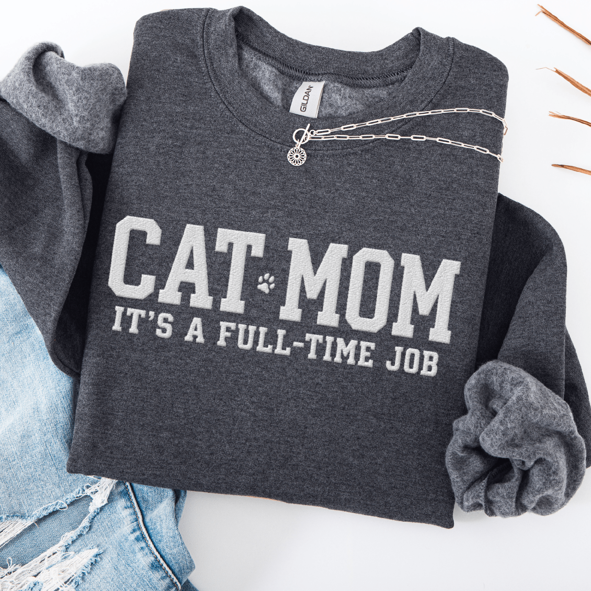 Dark Heather cat mom embroidered sweatshirt with “Cat Mom It’s A Full-Time Job” text, folded flat on light denim