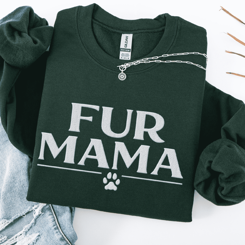 Forest Green fur mama embroidered sweatshirt with paw print detail, folded flat on light denim
