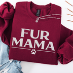 Maroon fur mama embroidered sweatshirt with paw print detail, folded flat on light denim