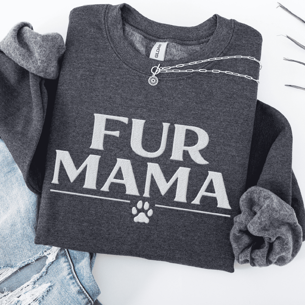 Dark Heather fur mama embroidered sweatshirt with paw print detail, folded flat on light denim